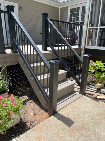 Composite deck stairs with black aluminum railing