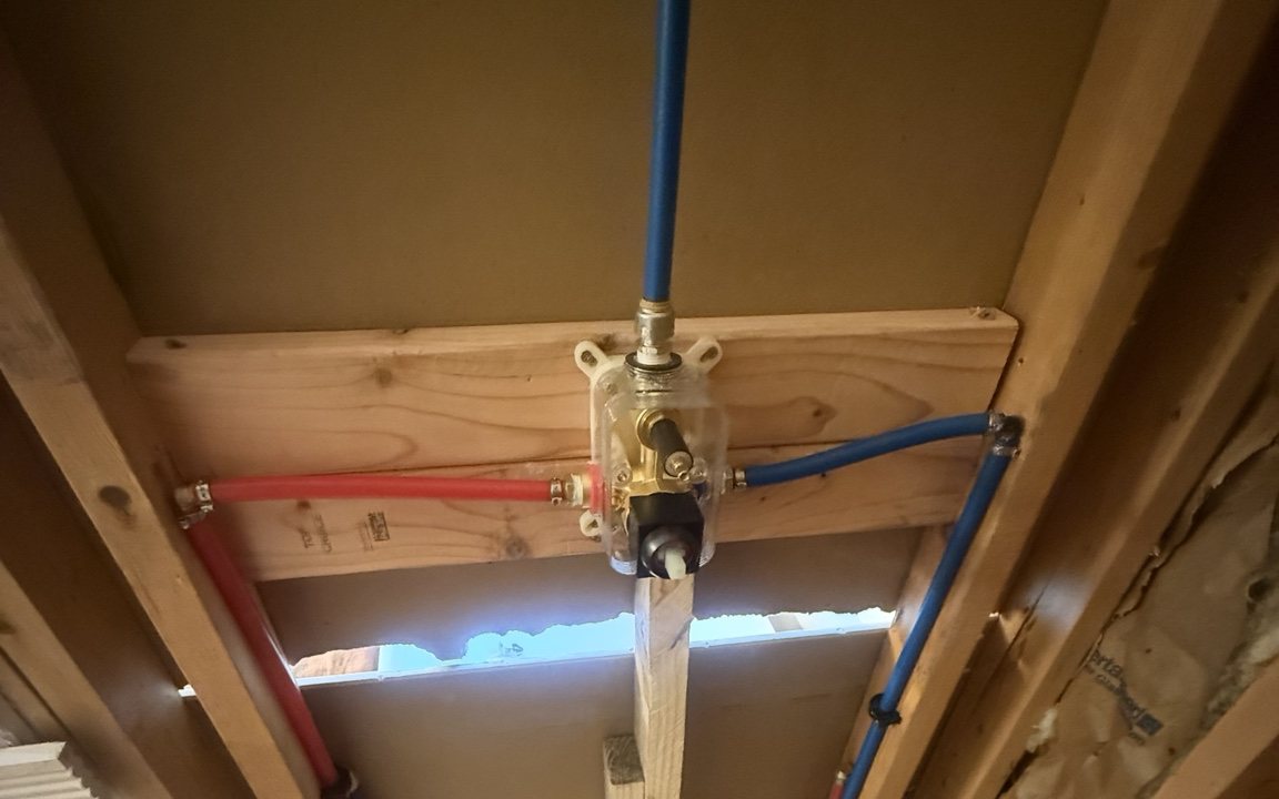 Shower valve and PEX water lines roughed in during a Wright Way Services bathroom job